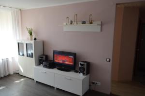 a living room with a flat screen tv and speakers at Baltic Dreams 2 in Jūrmala