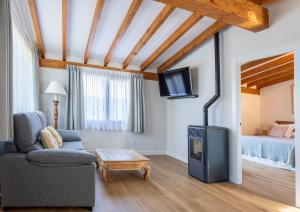 a living room with a couch and a fireplace at El Rincón de Lavalle in Loredo