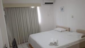 Un pat sau paturi într-o cameră la Silva Hospedagem