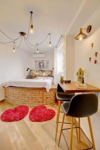 a bedroom with a bed and a desk and rugs at The Room in Dubrovnik