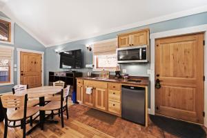 a kitchen with wooden cabinets and a wooden table at Moab Springs Ranch in Moab