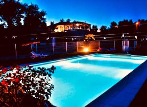 a swimming pool in front of a house at night at Casa da Quinta da Prelada Simão in Celorico de Basto