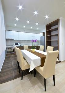 a kitchen and dining room with a table and chairs at Villa Cavar, Apartments Close to the Beach in Makarska