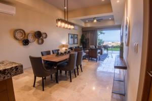 a dining room with a table and chairs at Quivira Los Cabos Condos and Homes -Vacation Rentals in Cabo San Lucas