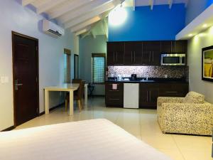 a kitchen and living room with a couch and a table at Quints Travelers Inn in Willemstad