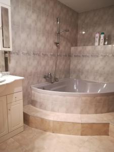 a bathroom with a bath tub and a sink at Hostal Brunete in Brunete