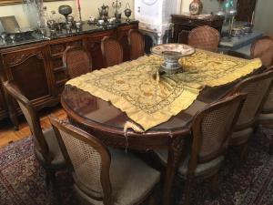 a dining room table with a yellow table cloth on it at Elites 1 in Alexandria
