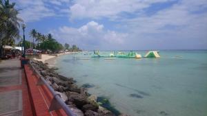a playground in the water next to a beach at le petit coin de paradis in Sainte-Anne
