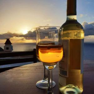 a bottle of wine sitting next to a glass at Casa rural Los Órganos de Arguamul in Vallehermoso