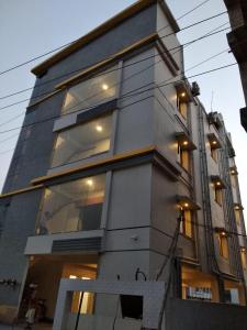 a tall building with many windows on it at Samsan Residentia in Visakhapatnam