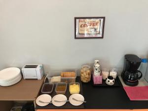 a table with food and a coffee maker on it at Super 8 Hotel @ Bayan Baru in Bayan Lepas