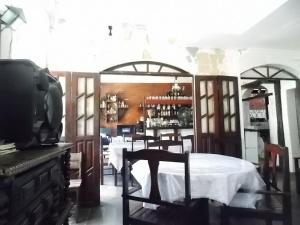 a dining room with a table and a chair at A meson Suites in Salvador