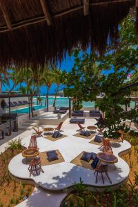 a beach with lounge chairs and the ocean at Lotus Beach Hotel - Adults Only in Isla Mujeres