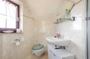 a bathroom with a sink and a toilet at Stadthaus Waren in Waren +68 photos