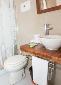 a bathroom with a toilet and a sink at Hotel Playa Brava in Punta del Este