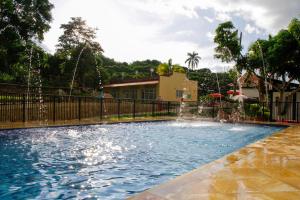 a swimming pool with fountains in a yard at Finca Hotel Villa Cristina in La Mesa