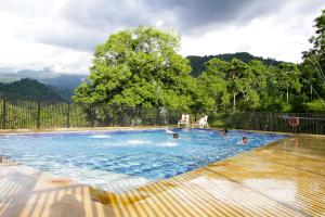 a group of people swimming in a swimming pool at Finca Hotel Villa Cristina in La Mesa