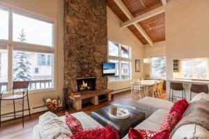 a living room with a couch and a fireplace at Vorlaufer Steps to Vail Village in Vail
