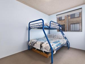 a bunk bed in a room with a window at Granada in The Entrance