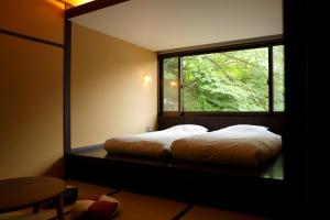 Posteľ alebo postele v izbe v ubytovaní Negiya Ryofukaku