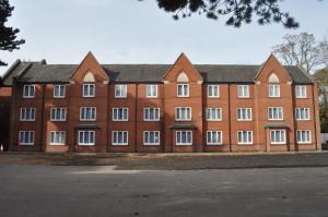 a large red brick building with white windows at The Collection Hotel Birmingham in Birmingham