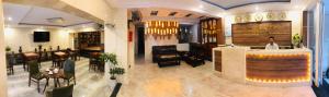a woman standing at a bar in a restaurant at Binh Duong 2 Hotel in Hue