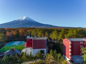 a building with a mountain in the background at Fuji Premium Resort in Fujikawaguchiko
