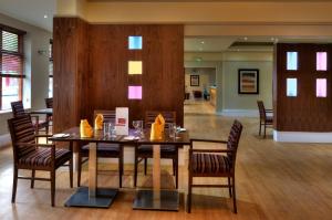 a dining room with a table and chairs at The Collection Hotel Birmingham in Birmingham