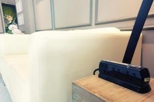 a router sitting on a table next to a couch at The Loft Plaza Hotel in Bangi