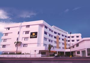 a white building with a sign on it at PROXY by The Oriental Albay in Legazpi