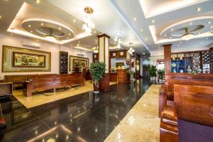a lobby with wooden benches in a building at ĐẠI THÀNH PHÚC in Hai Phong