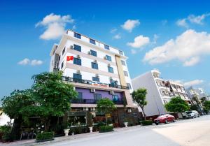 a tall white building on the side of a street at ĐẠI THÀNH PHÚC in Hai Phong