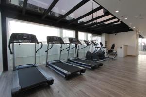 a row of treadmills in a gym with windows at 85 SOHO Premium Residences in Yangon