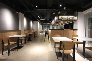 a row of tables and chairs in a restaurant at 85 SOHO Premium Residences in Yangon