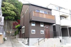 a brown house with a red door at FLAG Zushi in Zushi