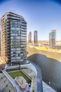 a rendering of a tall building next to a body of water at Orange Stay Apartments in Melbourne