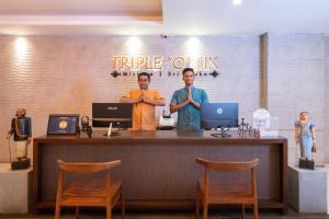 two men standing at a counter with their arms crossed at Triple O Six in Mirissa