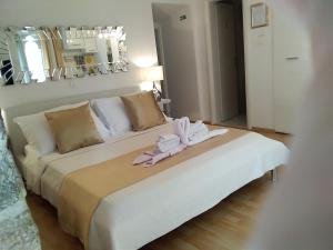 a large white bed with towels on top of it at Private Apartments In Diocletians Palace in Split