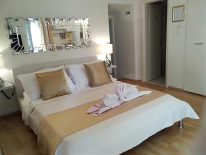 a bedroom with a large white bed with towels on it at Private Apartments In Diocletians Palace in Split