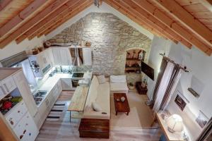 an overhead view of a kitchen with a stone wall at Luminous 2BD stone Apt in the alleys of Corfu town in Corfu