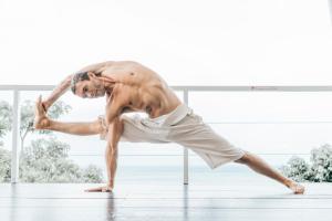 a shirtless man dancing on a dance floor at Vikasa Yoga Retreat in Lamai