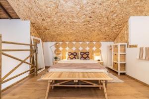 a bedroom with a bed and a wooden table at FARO DOWNTOWN STUDIOS in Faro