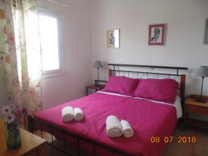 a bedroom with a bed with two towels on it at Hippokratis Apartments in Gerani