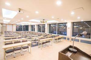 a lecture hall with tables and chairs and a microphone at Hyundai Elliot Hotel and Resort in Pyeongchang