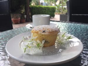 a pastry on a plate on a table with a cup at Country House Paola in Marina di Gioiosa Ionica