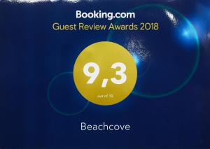 a yellow sign that reads guest review awards at Beachcove in Pereybere