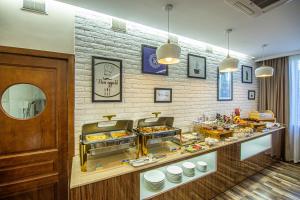 a bakery with a buffet of food on display at Rayan Hotel in Osh