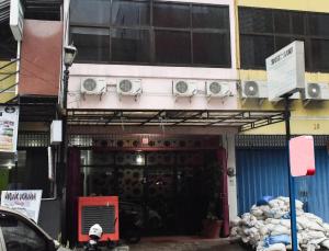 a building with a door with speakers on it at RedDoorz at Pettarani Square Makassar in Makassar