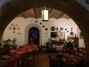 a restaurant with two tables with red and white tablecloths at Colors Tastes in the Montagnola Senese in Valiano 