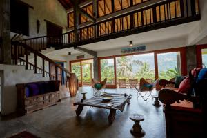 a living room with a table and some chairs at Bamboo Villa Kandy in Digana